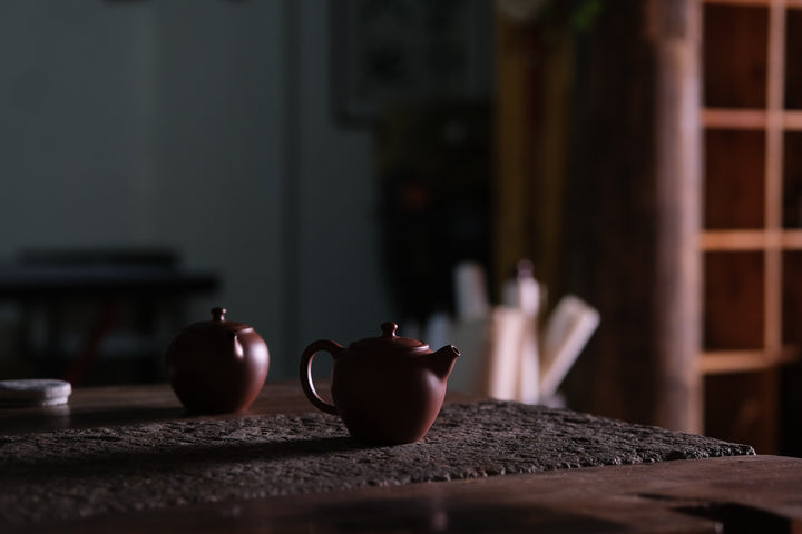 Two yixing clay pots on the Chinese artist studio stone table - for the Chinese tea course