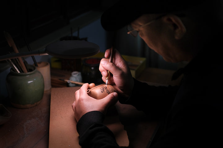 Yixing teapot artist at work, national level master in China, genuine seasoned clay