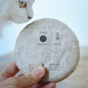 Chinese white tea aged Yueguangbai moonlight from Yunnan, pressed cake from organic forest