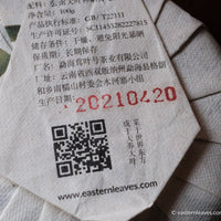 Paliang mountain pu'er shengpu in pressed cake, from Yunnan, China, with bamboo tray. 2021 spring harvest vintage