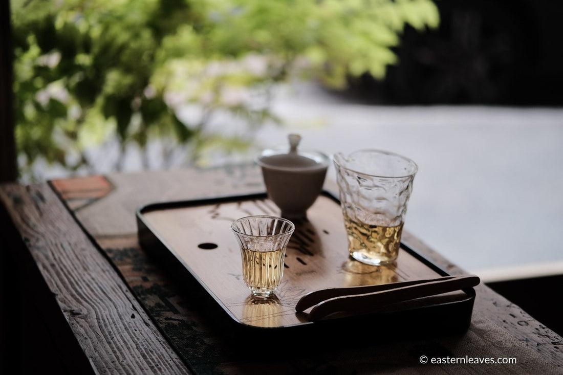 Paliang mountain pu'er shengpu in pressed cake, from Yunnan, China, with bamboo tray. 2021 spring harvest vintage, with glass cup and gongfucha tea set