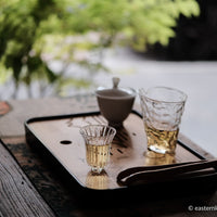 Paliang mountain pu'er shengpu in pressed cake, from Yunnan, China, with bamboo tray. 2021 spring harvest vintage, with glass cup and gongfucha tea set
