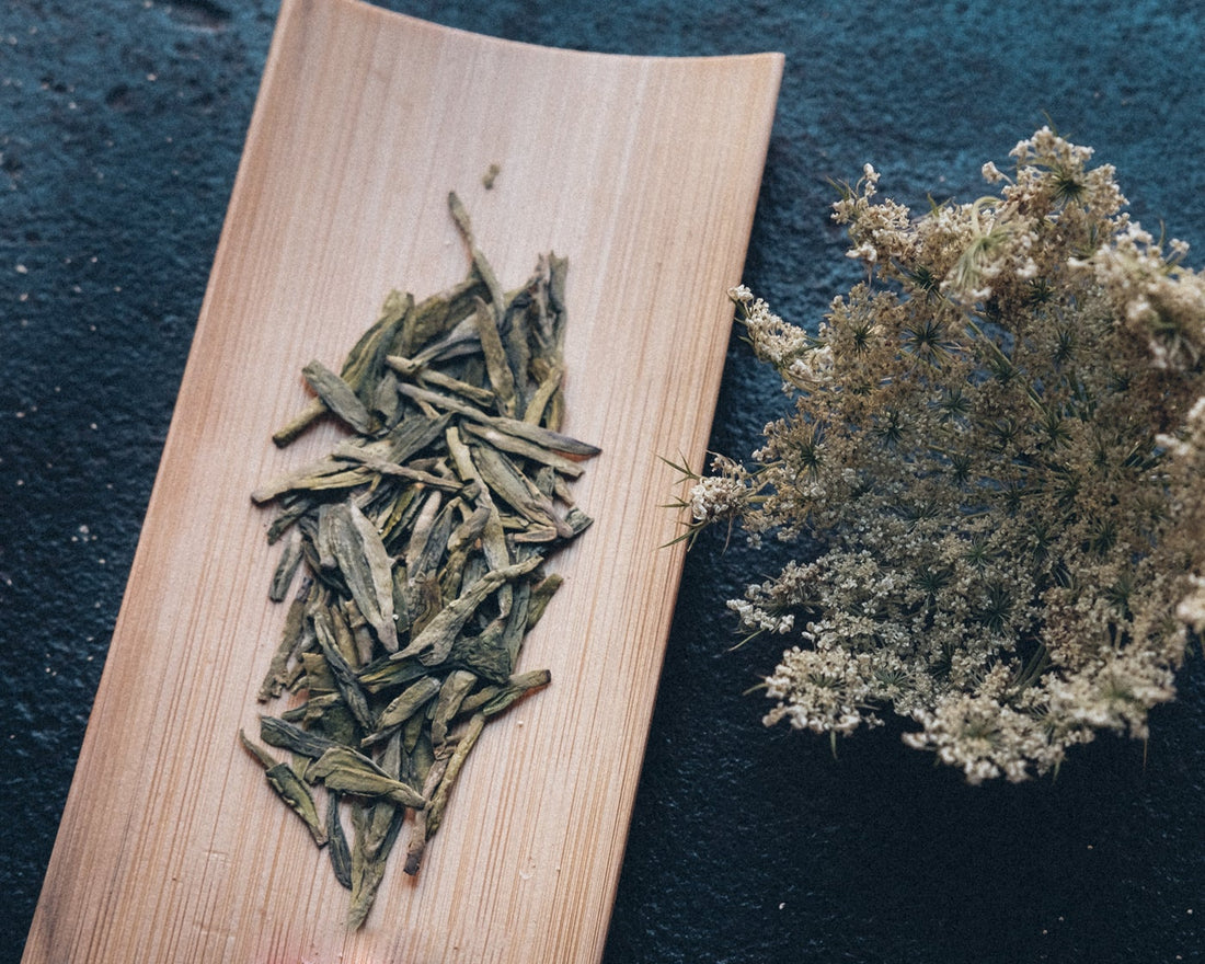 Longjing from Xihu Meijiawu, Chinese green tea loose-leaf in dry leaves with white dry flower, pre-qingming