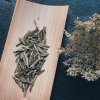 Longjing from Xihu Meijiawu, Chinese green tea loose-leaf in dry leaves with white dry flower, pre-qingming