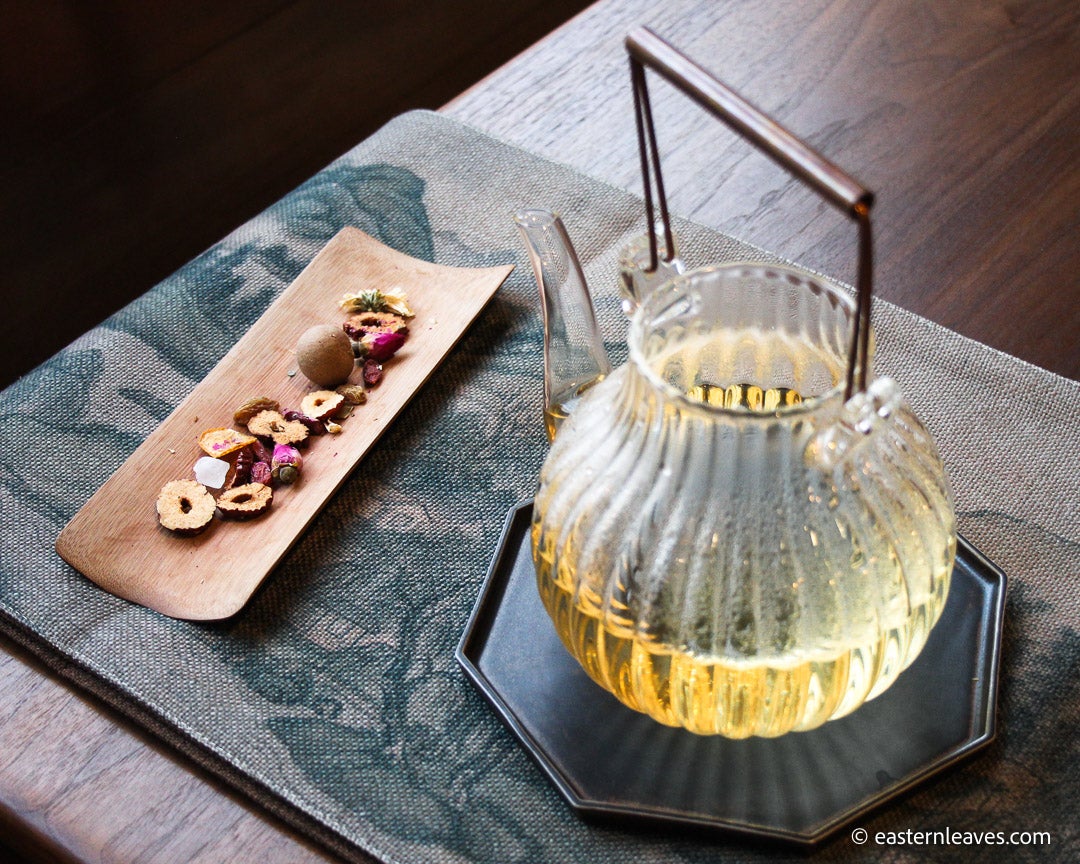 Eight treasures Chinese herbal tea with longan, chrysanthemum, rose blossoms, tangerine peel, jujubes, goji berries, raisins, rock sugar