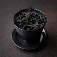 Dahongpao rock tea from Zhenyan premium area, Wuyi, Wuyishan, in China. Loose leaf wulong tea in black cup teaware