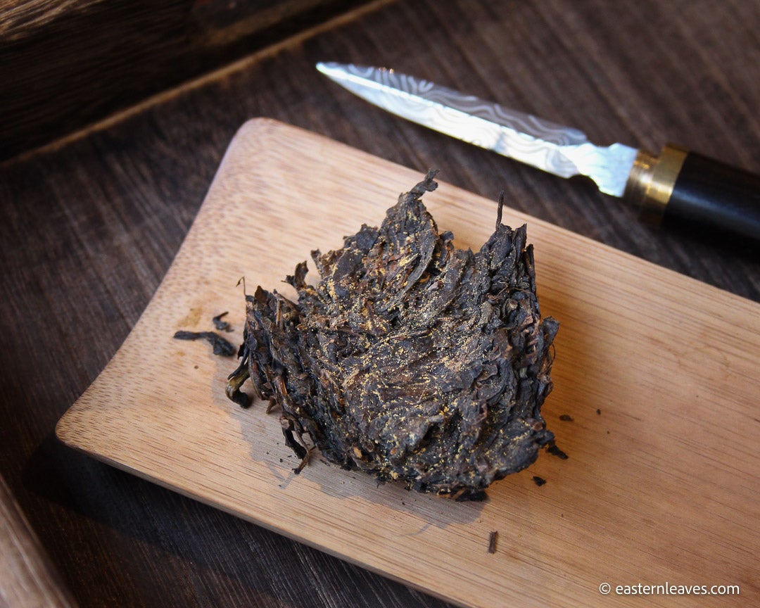 Fucha dark black tea, fermented, in original bamboo leaf basket; 2007 harvest from China with golden flowers