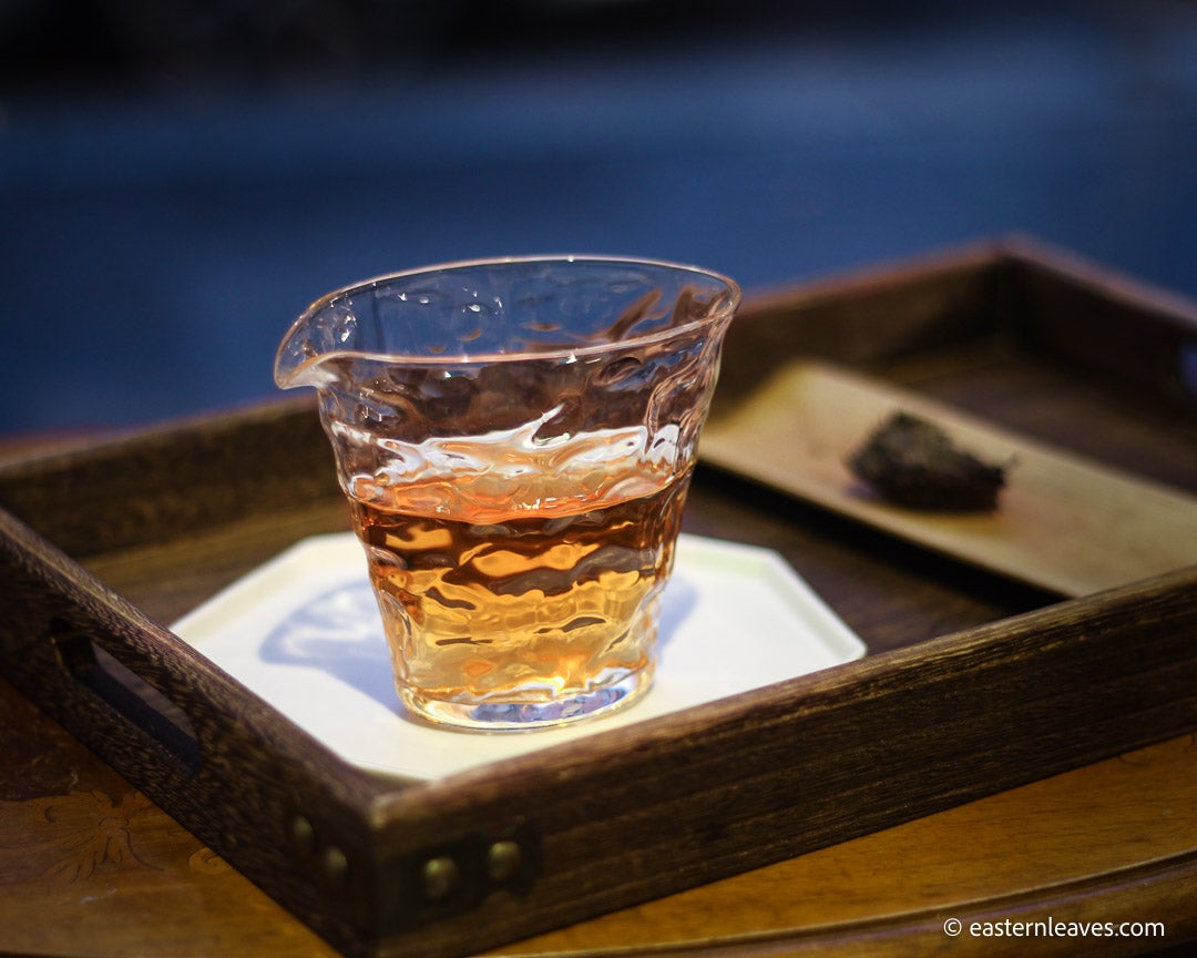 Fucha dark black tea, fermented, in original bamboo leaf basket; 2007 harvest from China in glass server