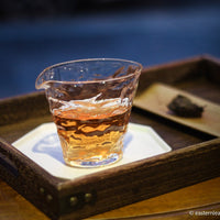 Fucha dark black tea, fermented, in original bamboo leaf basket; 2007 harvest from China in glass server