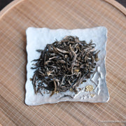Jasmin green tea Chinese in loose-leaf, scented in high quality processing, on silver tray and bamboo