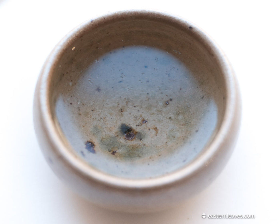 Jasmin green tea Chinese in loose-leaf, scented in high quality processing, infusion liquor in white ceramic cup,