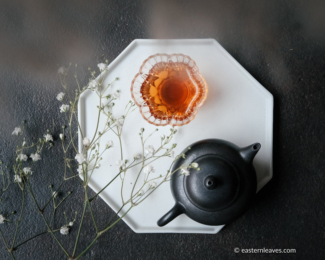 Liubao cha dark black tea, fermented, in original bamboo leaf basket; 2006 harvest from China with  black yixing teapot