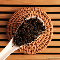 Tianjian cha dark black tea, fermented, in original bamboo leaf basket; 2014 harvest from China