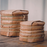 Bamboo tong of Pu'er shengpu Chinese tea pressed cake brick vintage and aged, 2012 spring harvest, from Nannuo in Yunnan