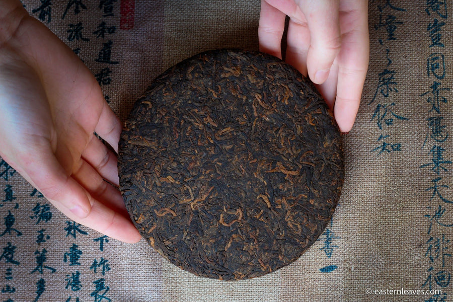 Detail of cake of pu'er shupu tea in pressed cake brick, fermented, from Yiwu mountain and ancient trees high quality tea