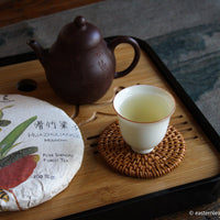 pu'er shengpu tea forest in Huazhuliangzi  mountain, high altitude in Yunnan, China; stone pressed cake with yixing teapot and ceramic cup