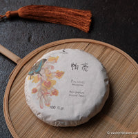 Paliang mountain pu'er shengpu in pressed cake, from Yunnan, China, with bamboo tray. 2021 spring harvest vintage
