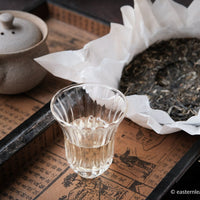 Paliang mountain pu'er shengpu in pressed cake, from Yunnan, China, with bamboo tray. 2021 spring harvest vintage, with glass cup and gongfucha tea set