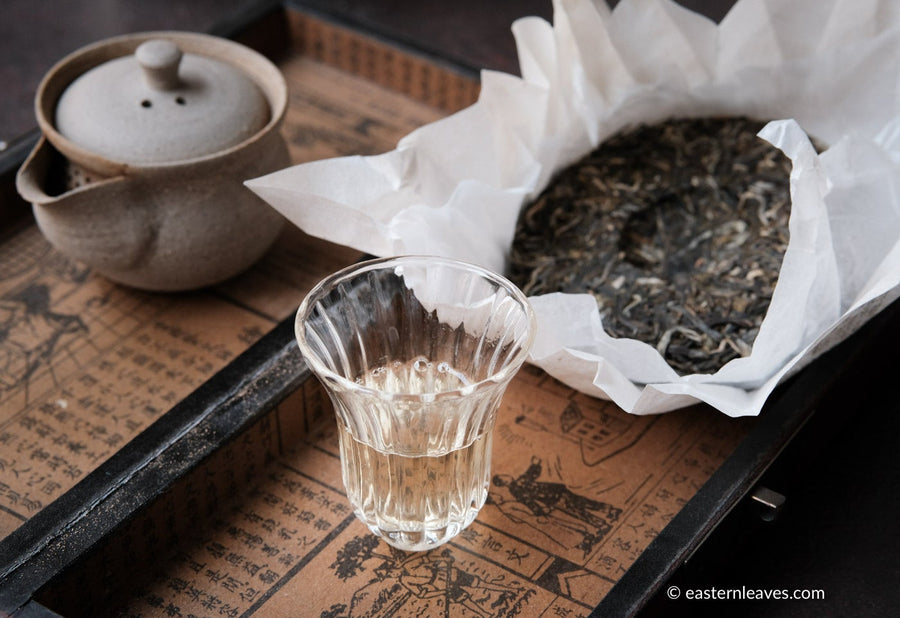 Paliang mountain pu'er shengpu in pressed cake, from Yunnan, China, with bamboo tray. 2021 spring harvest vintage, with glass cup and gongfucha tea set