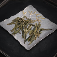 Longjing from Xihu Meijiawu, cultivar 43 Chinese green tea pre-qingming, loose-leaf on silver tray with golden flowers 