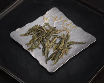 Longjing from Xihu Meijiawu, cultivar 43 Chinese green tea pre-qingming, loose-leaf on silver tray with golden flowers 