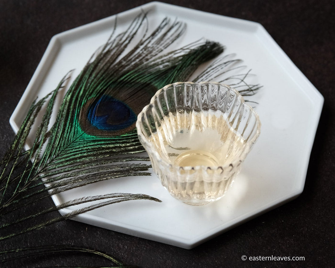 Dancong Yashixiang duck shit fragrance wulong tea from Guangdong China, served in glass cup teaware with peacock leaf