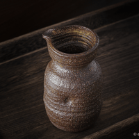 Dai minority Gongdaobei, tea pitcher, handcrafted in Yunnan, China - brown rough texture clay, 250ml, on wood
