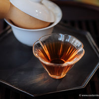 ormanthus scented red tea from China, loose leaf high quality tea with golden blooms infused in glass cup teaware