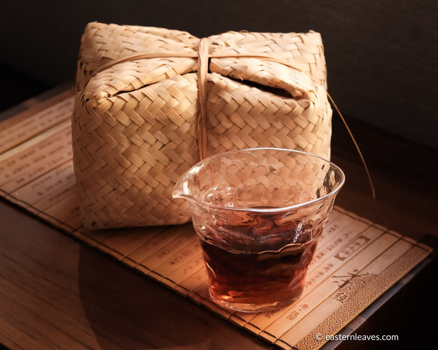 Tianjian cha dark black tea, fermented, in original bamboo leaf basket; 2014 harvest from China in glass server